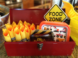 Construction 3rd birthday party blast | Halfpint Party - food zone. Plates, napkins, and cutlery arranged in an old toolbox!