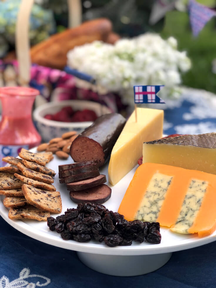 Meat and cheese tray with plaid flag pick at charming summer picnic party